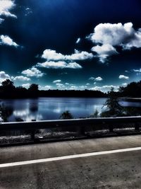 Calm lake with trees in background