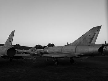 Airplane on airport runway against sky