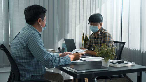 Side view of business colleagues working at office