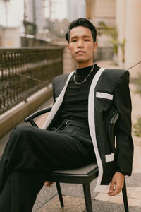 Portrait of young woman sitting on chair