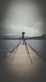 Man photographing on sea against sky