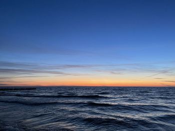 Scenic view of sea against blue sky during sunset