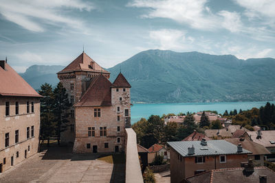 Buildings in town against sky