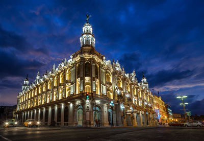 Illuminated national theater of cuba by road against sky at night