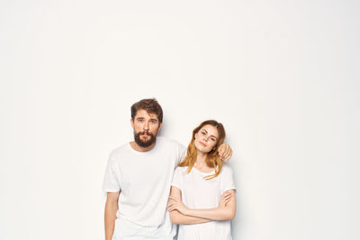 Portrait of young couple against white background