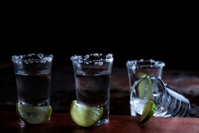 Shot glasses against black background