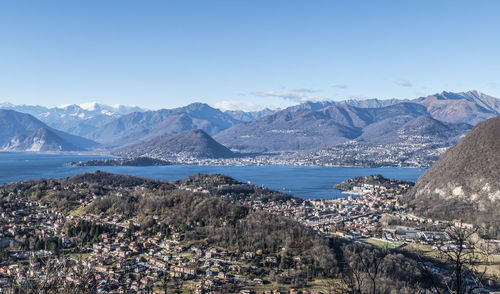 Scenic view of sea by mountains against sky