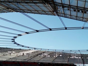 The roof construction of a soccer stadium and clear blue sky