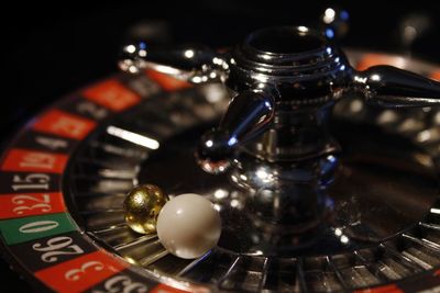 Close-up of roulette wheel with balls at casino