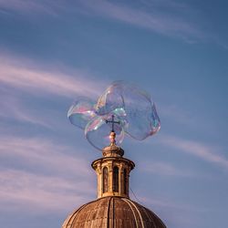 Low angle view of bubbles against sky