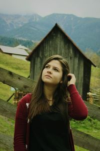 Beautiful young woman standing on mountain