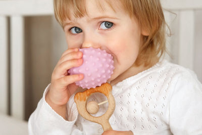 Close-up of girl blowing bubbles at home