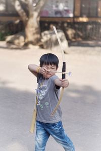 Cute boy aiming arrow