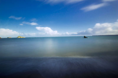 Scenic view of sea against blue sky