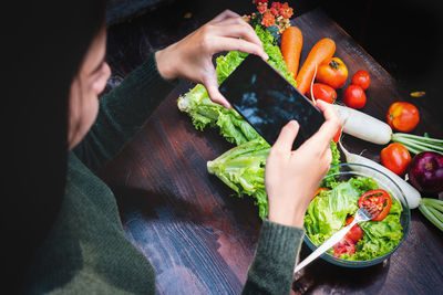 High angle view of woman preparing food on table