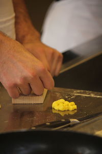 Midsection of man preparing food in kitchen