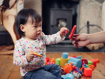 Cute girl playing with toys at home