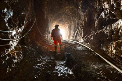 Rear view of man standing in tunnel