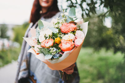 Woman holding flower bouquet