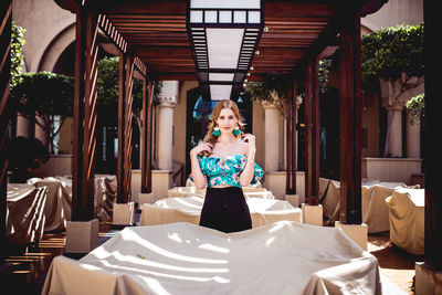 Rear view of woman sitting on table in restaurant