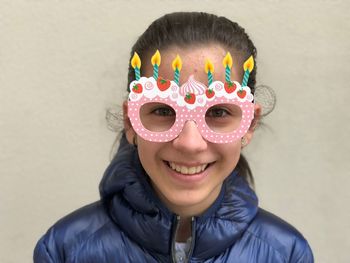 Portrait of smiling teenage girl wearing novelty glasses