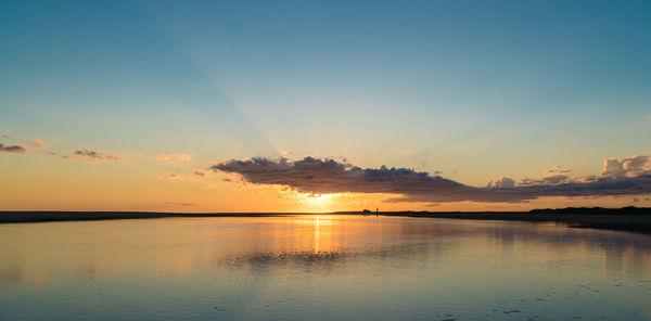 Scenic view of lake against romantic sky at sunset