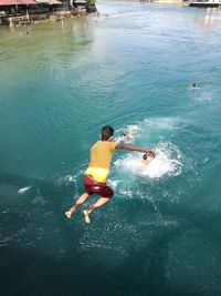 High angle view of boy swimming in water