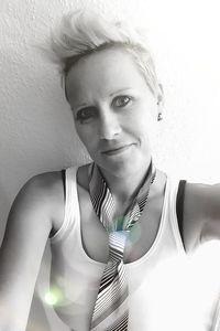 Portrait of woman standing against wall