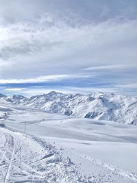 Scenic view of snow covered mountains against sky