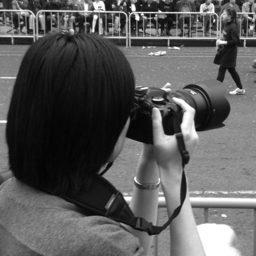 lifestyles, focus on foreground, leisure activity, childhood, girls, casual clothing, elementary age, rear view, boys, day, togetherness, street, incidental people, person, sunlight, standing