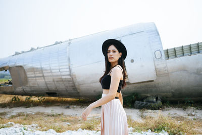 Portrait of woman standing against sky