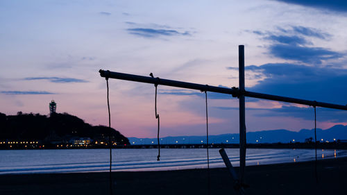 Silhouette bridge against sky at dusk