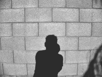 Silhouette man standing on tiled floor