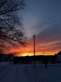 Silhouette trees against sky during winter