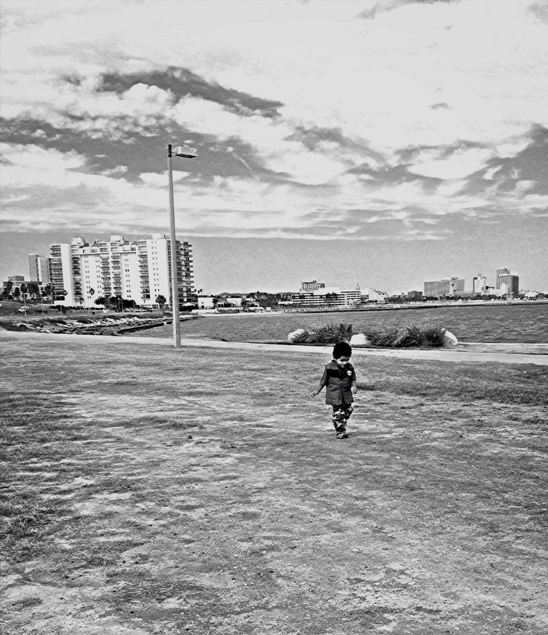 full length, sea, lifestyles, leisure activity, water, sky, rear view, casual clothing, beach, men, cloud - sky, standing, walking, built structure, childhood, shore, boys, day