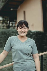 Portrait of smiling woman standing outdoors