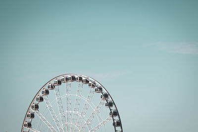 Low angle view of ferris wheel against clear sky