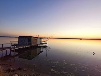 Scenic view of sea against clear sky during sunset