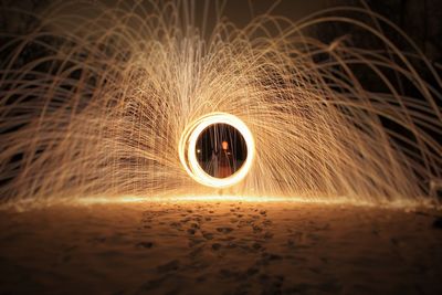 Man standing with abstracts illuminated swirls on shore