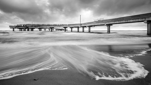 Bridge over sea against sky