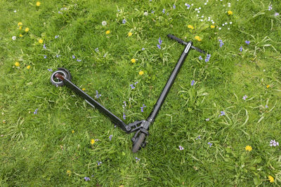 E-scooter lying on flower meadow