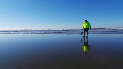 Full length of woman standing on beach