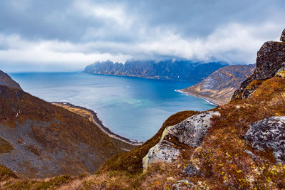 Scenic view of sea and mountains against sky