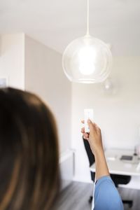 Young woman holding light bulb