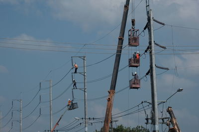 Low angle view of electricity pylon against sky