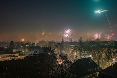 High angle view of city lit up at night