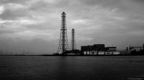 Crane by sea against sky