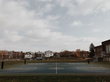 Basketball hoop on city against sky