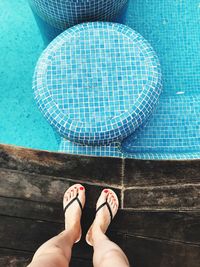 Low section of woman standing on poolside