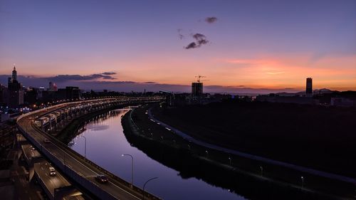 High angle view of bridge over river against sky during sunset
